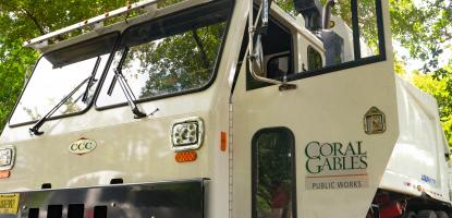 Photo of a solid waste truck with the door open