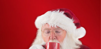 Santa drinks from a red mug in a red background