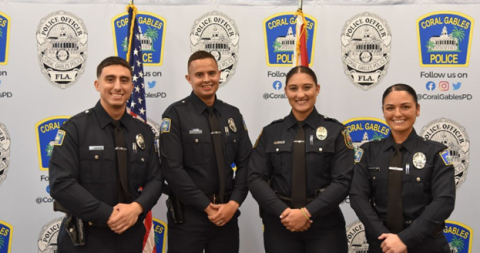 Four newly sworn in Coral Gables police officers standing side by side