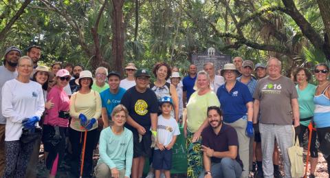 Volunteers standing together with pinewoods behind and over them